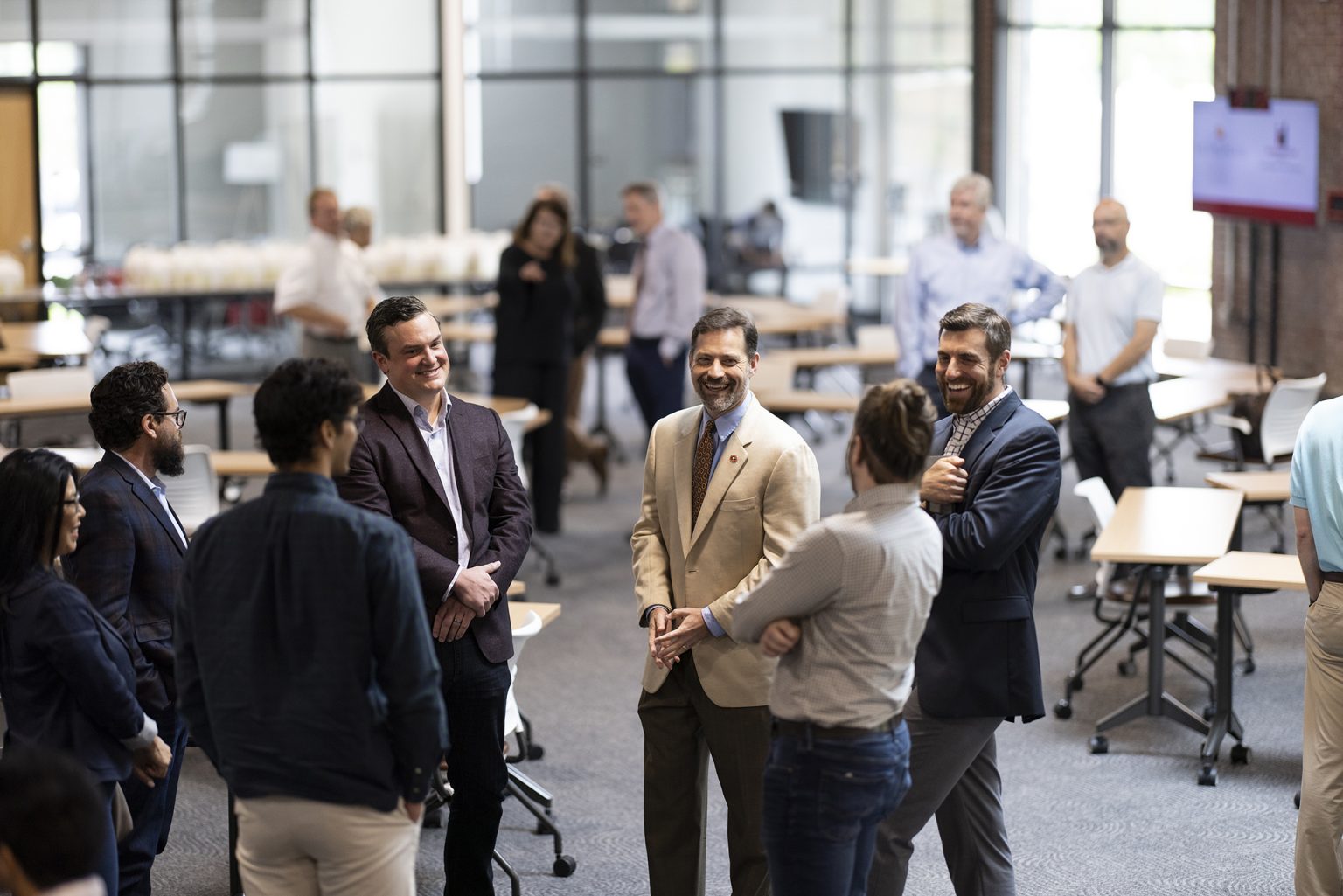 (L-R) Metropolis executives Elaine Peng, David Fontenot, Salar Fahim and CEO Scott Edwards share a laugh with Vice President for Government Relations Toby Carr, New Media Institute academic professional Chris Gerlach, and Special Assistant to the President and Director for Strategy and Innovation Kyle Tschepikow before a lunch at the Innovation Hub. (Photo by Andrew Davis Tucker/UGA)