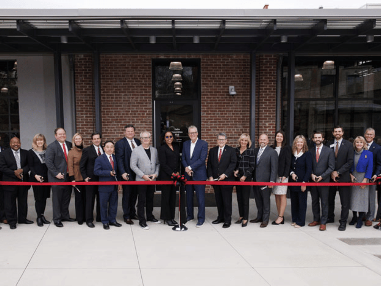 A group of Delta and UGA leadership gather for the ribbon cutting and dedication of the Delta Innovation Hub.