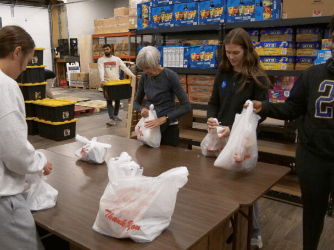 Volunteers assemble bags at a food bank in Athens.