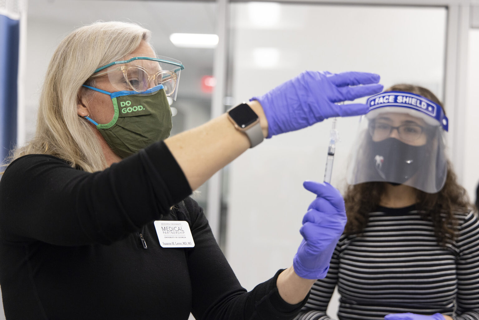 Physician and faculty member Dr. Suzanne Lester teaches second-year medical student Annelise Bonvillain how to draw up a vaccine during hands-on training in the clinical skills lab at the Medical Partnership on the Health Sciences Campus. (Photo by Andrew Davis Tucker/UGA)