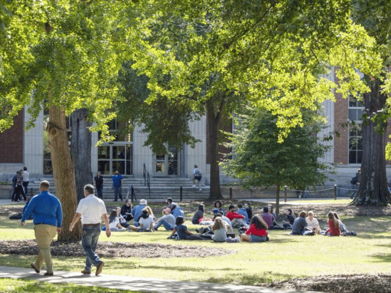 Students spend time outside in front of the Main Library at UGA.