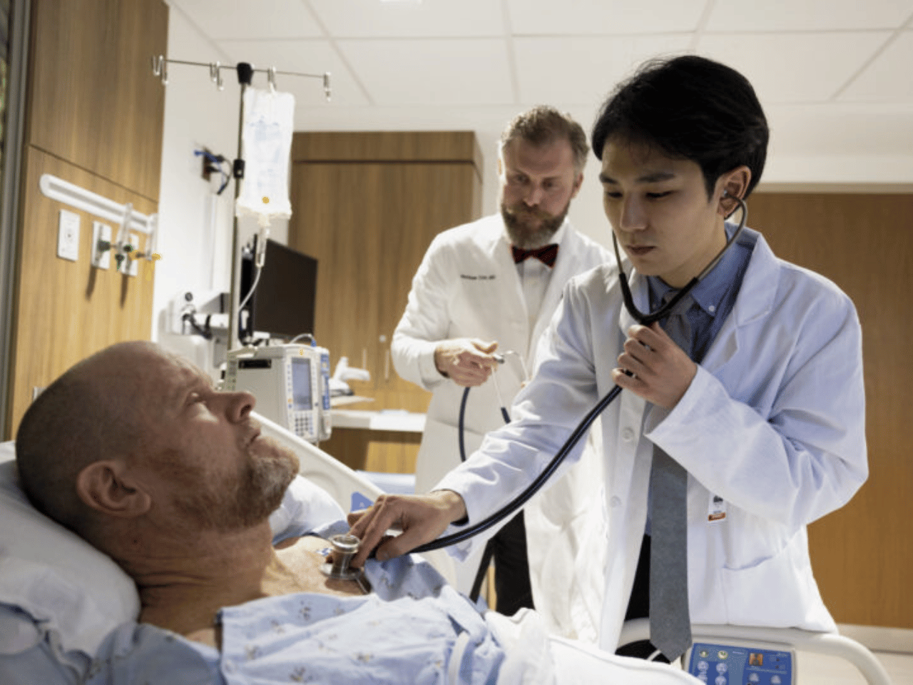 A medical student examines a patient.