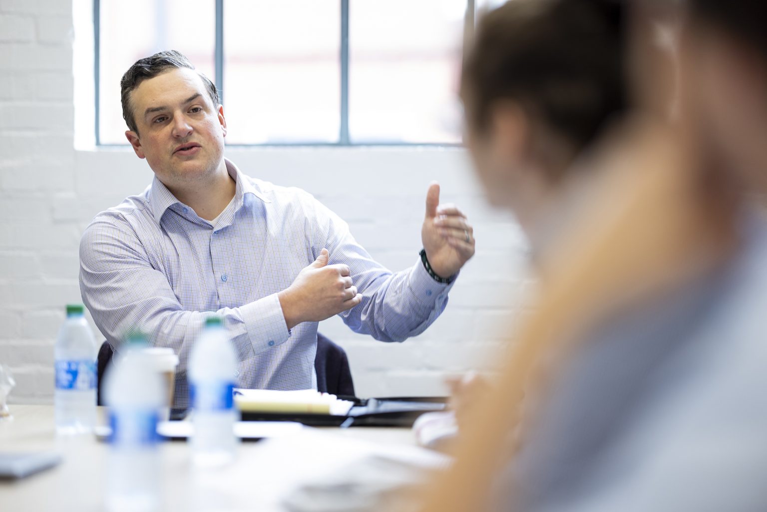 Metropolis CEO Scott Edwards talks with interns in a conference room at the Innovation Hub. (Photo by Andrew Davis Tucker/UGA)