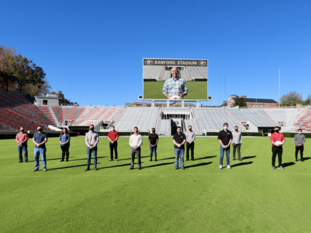 UGA student Veterans stand on Dooley Field at Sanford Stadium.