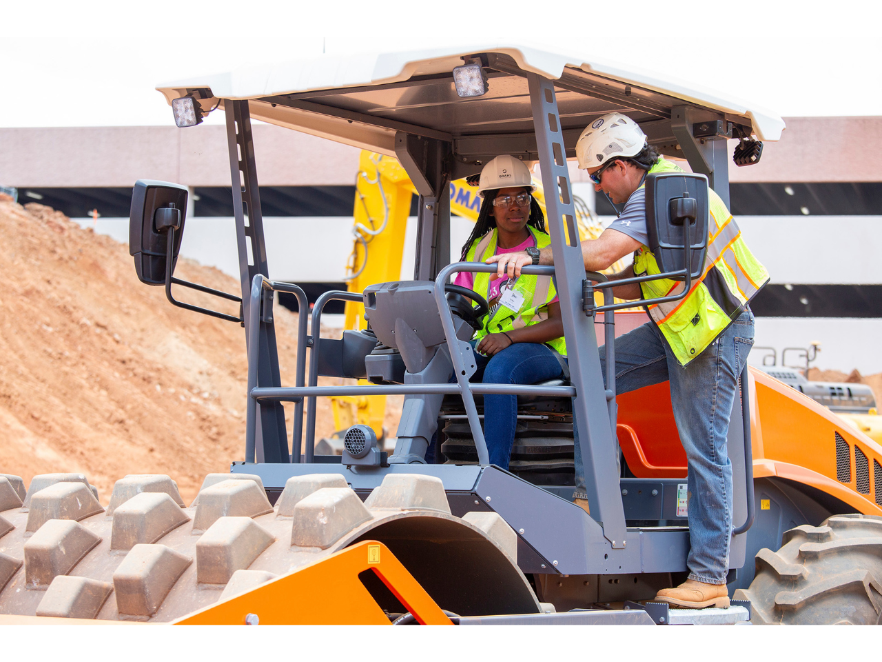 Ivey Nemorin, rising junior at Greater Atlanta Christian, gets ready to drive heavy equipment with the support of Shyanne Allgood of College Pro landscaping and construction.