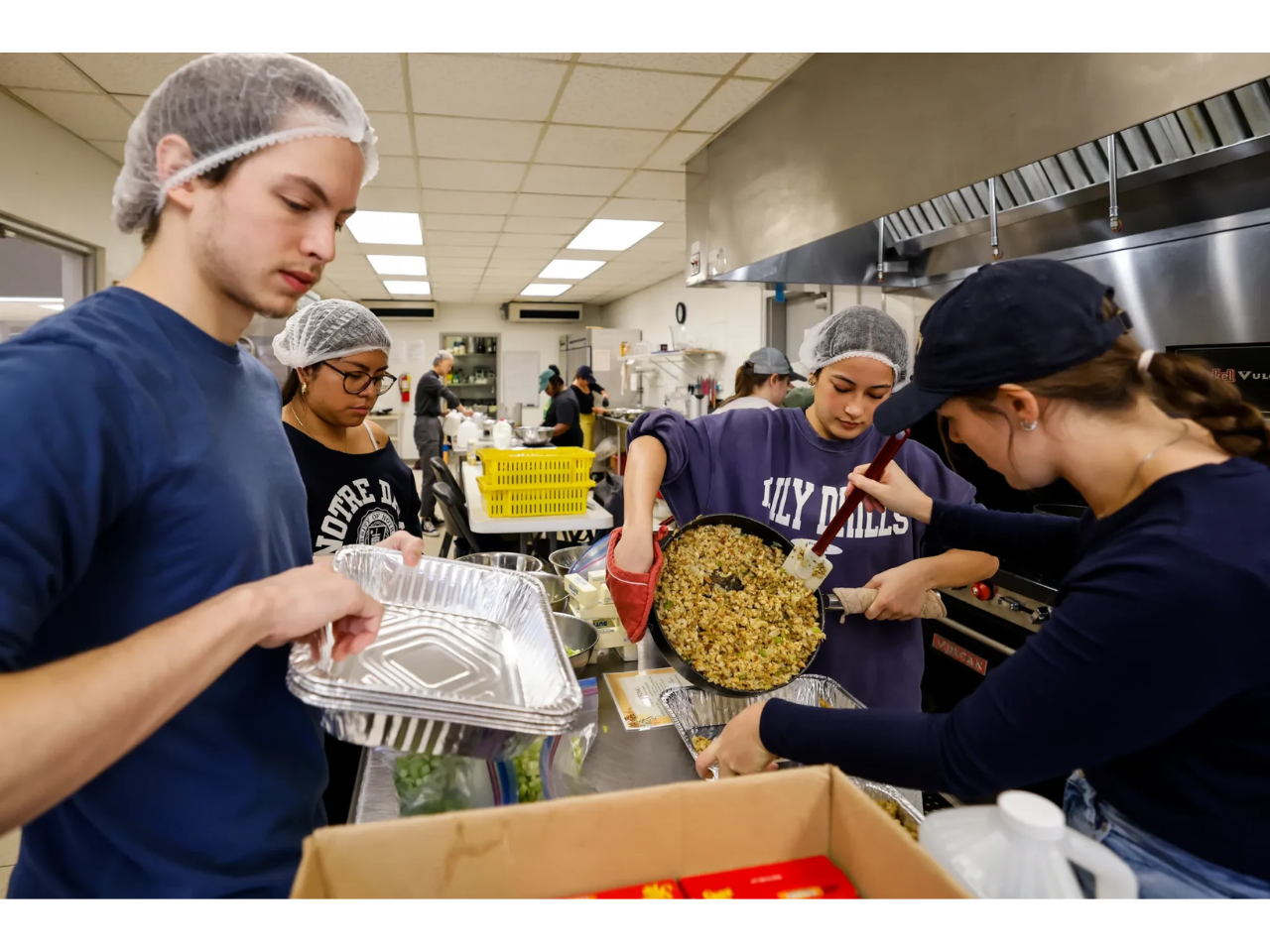 Campus Kitchen volunteers Jeffrey Smith, Sam Vazquez, Carly Velasquez, and Cecelia Pumpelly cook for Turkeypalooza.