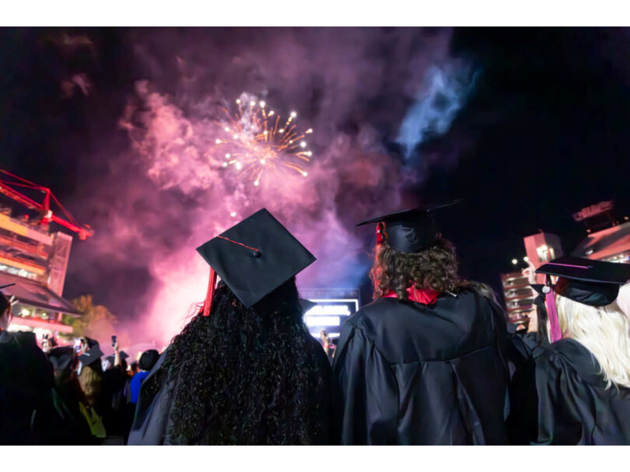 Graduating students celebrate during the fireworks display at the undergraduate Commencement ceremony in Sanford Stadium. (Dorothy Kozlowski/UGA)