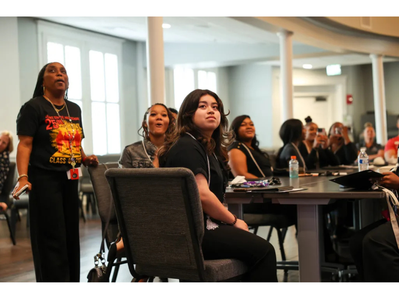 Genesis Rodriguez-Hernandez, center, along with fellow Georgia Possible graduates and Tonya Jones, left, counselor at Clarke Central High School and Georgia Possible coordinator for Clarke County School District, enjoy a nostalgic slideshow reflecting on their three-year journey in the Georgia Possible program. (Photo by Catherine Elrod)